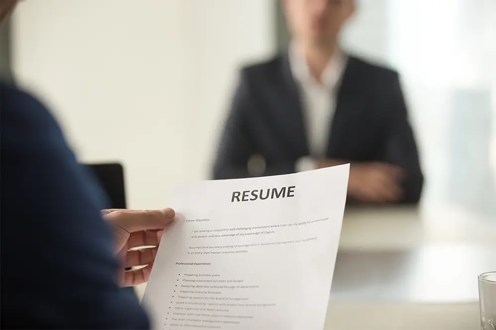 Employer reviews resume on a piece of paper