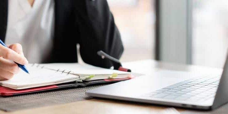 HR making notes in a notebook
