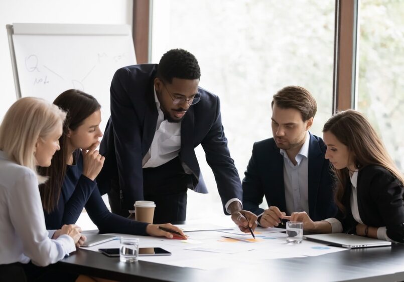 Confident african American male boss work cooperate with diverse team